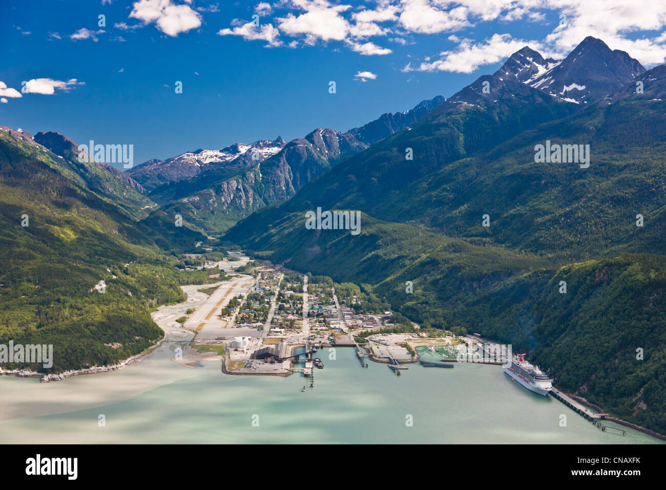 Aerial view of the city of Skagway with a cruise ship docked at port