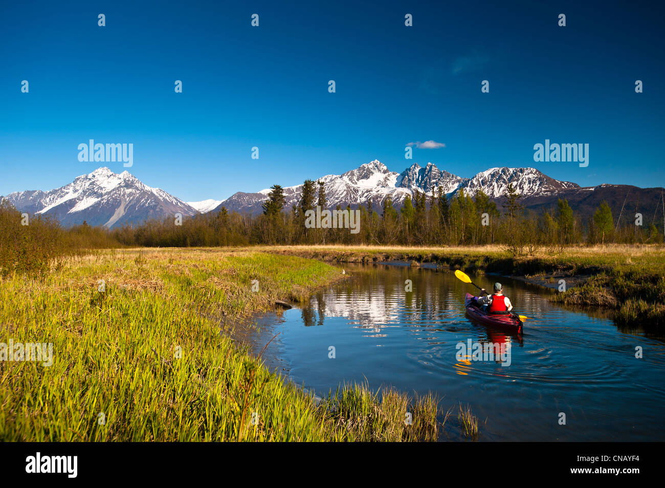 A man kayaking on Rabbit Slough in Palmer Haystack Flats Wildlife