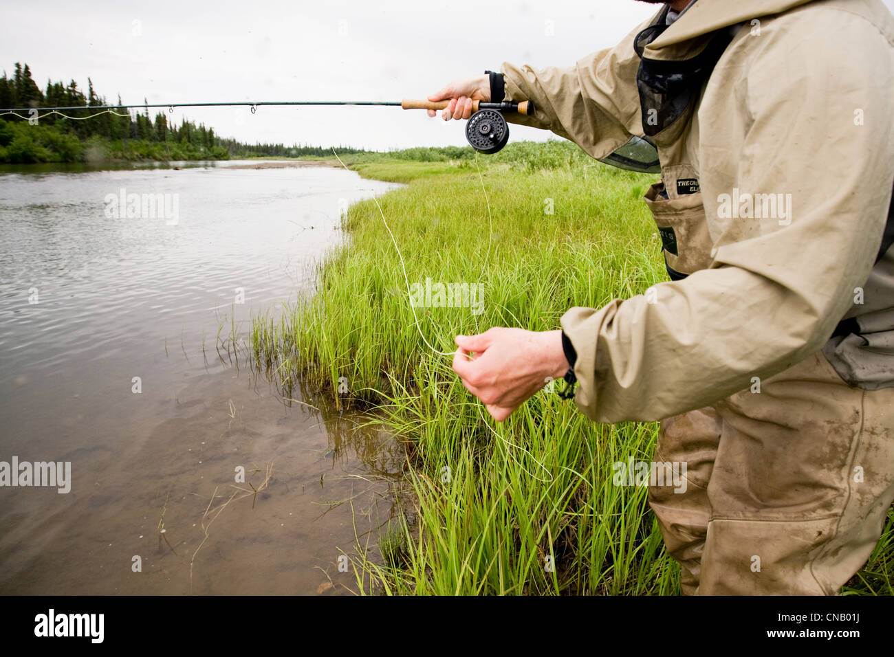 Fly fisherman fishing for salmon on the Mulchatna River in the Bristol