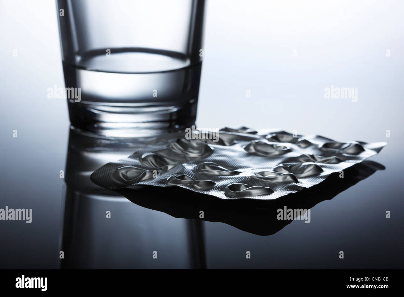Popped blister pack of pills and water Stock Photo Alamy