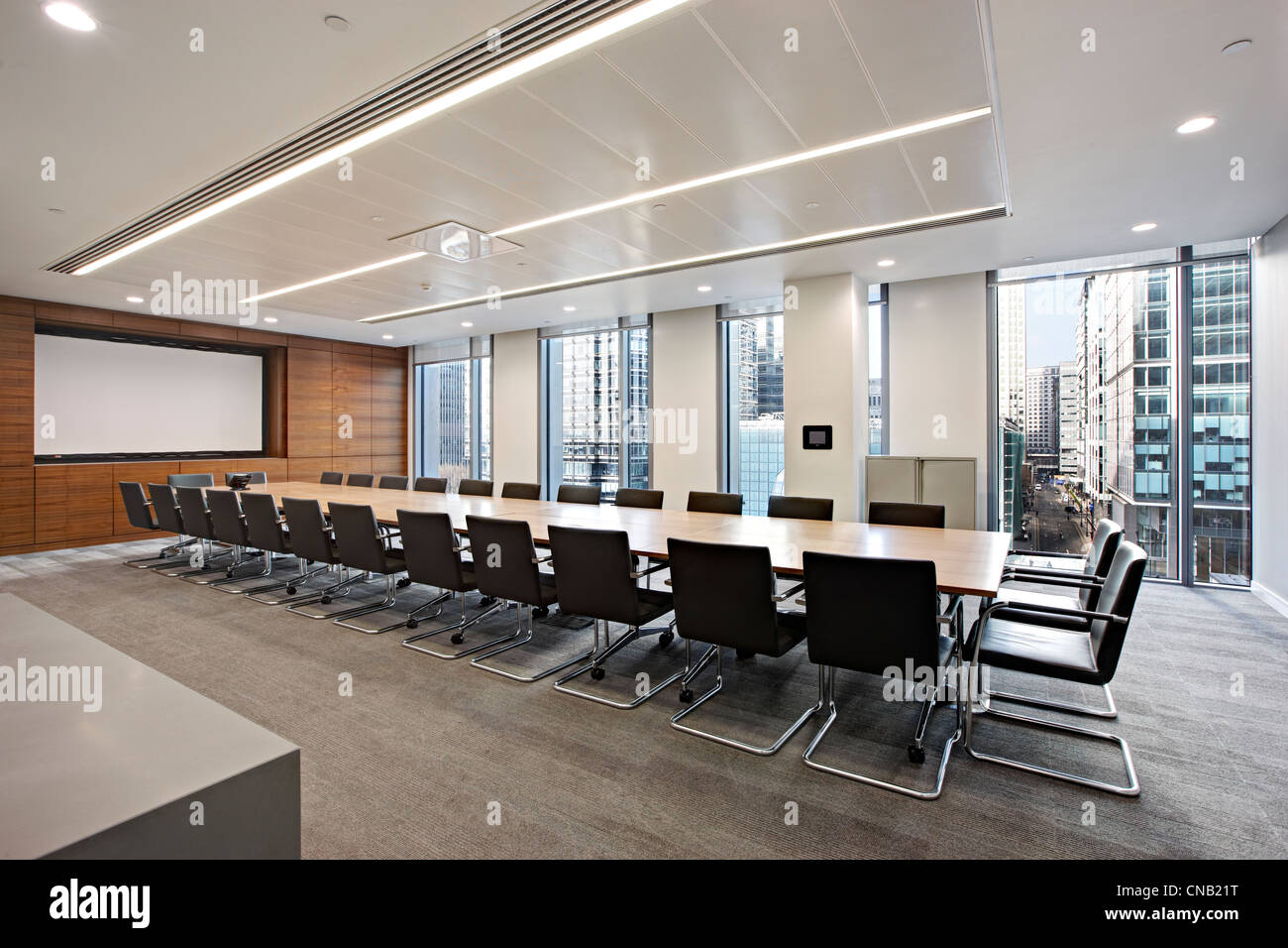 board room meeting room large table screen chairs Stock Photo