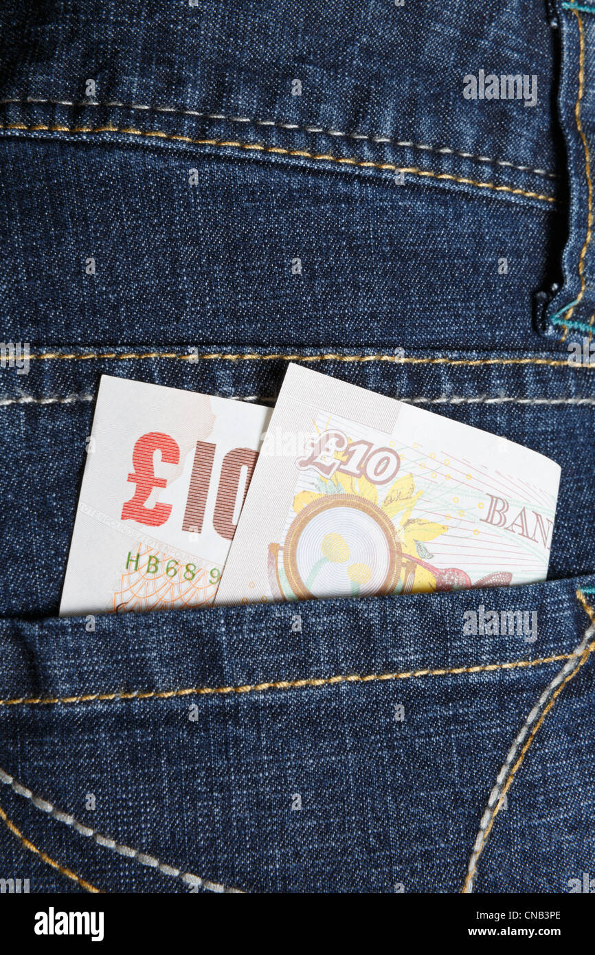 A ten pound note in the back pocket of a pair of women's blue denim