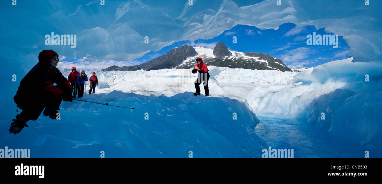Glacier hikers stand inside a blue ice cave on the Mendenhall Glacier, Juneau, Southeast Alaska, Summer Stock Photo