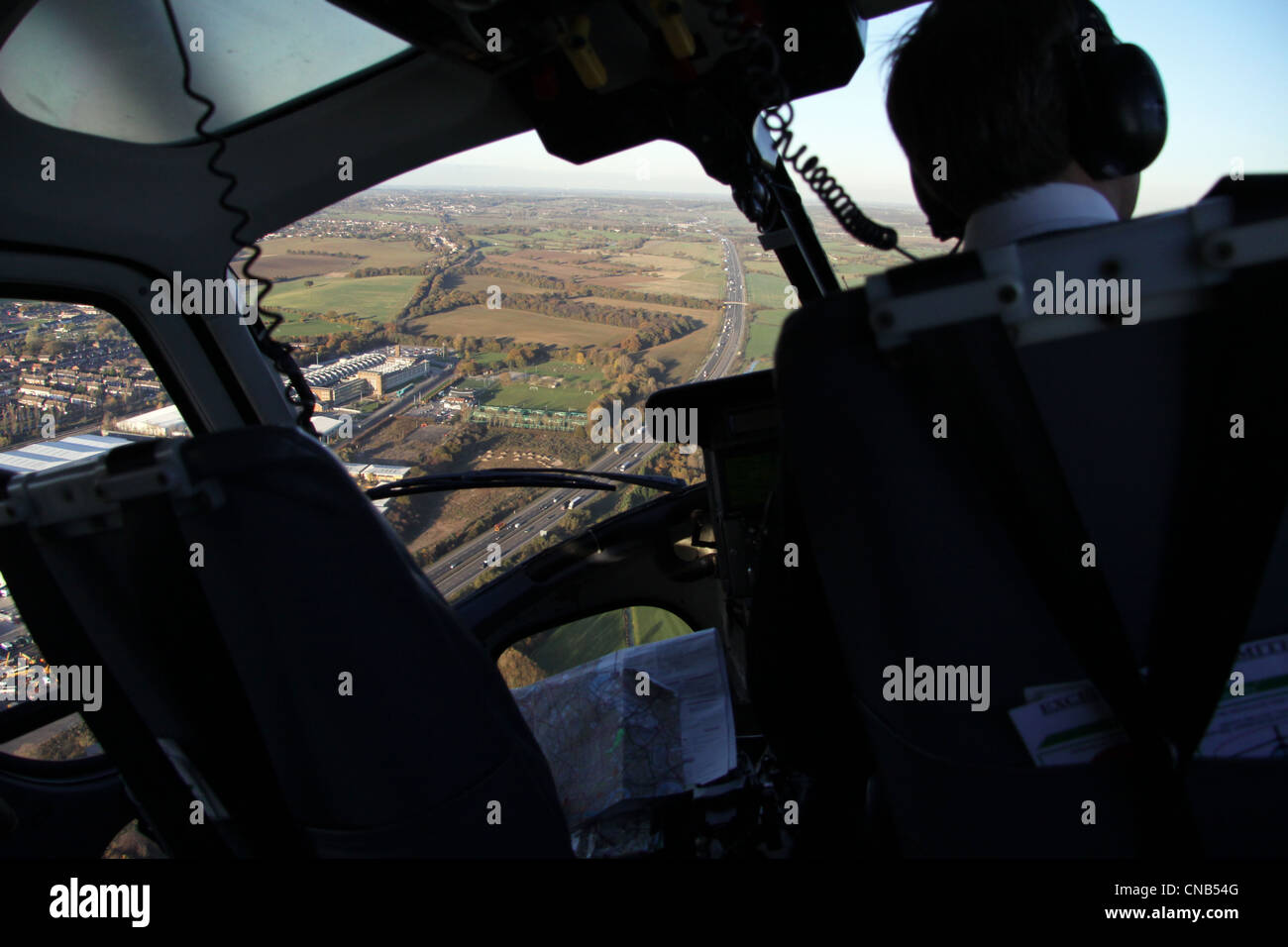 view from inside a twin Squirrel helicopter over the M11 Stock Photo