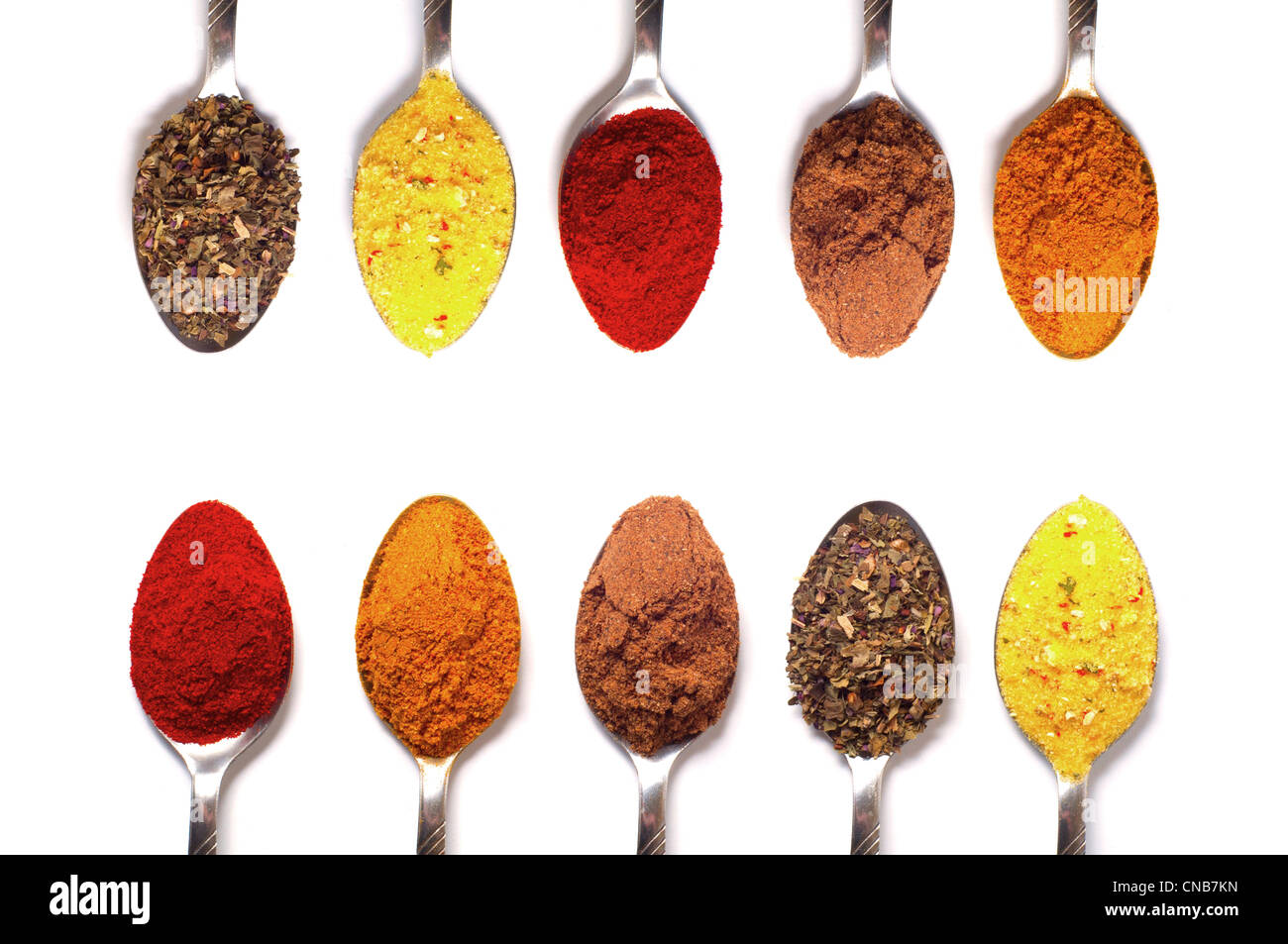 spices in the spoons on a white background Stock Photo