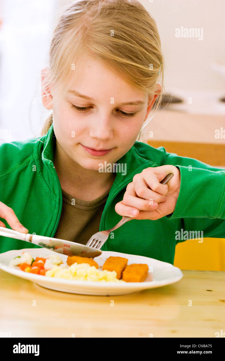 girl eating fish sticks Stock Photo Alamy