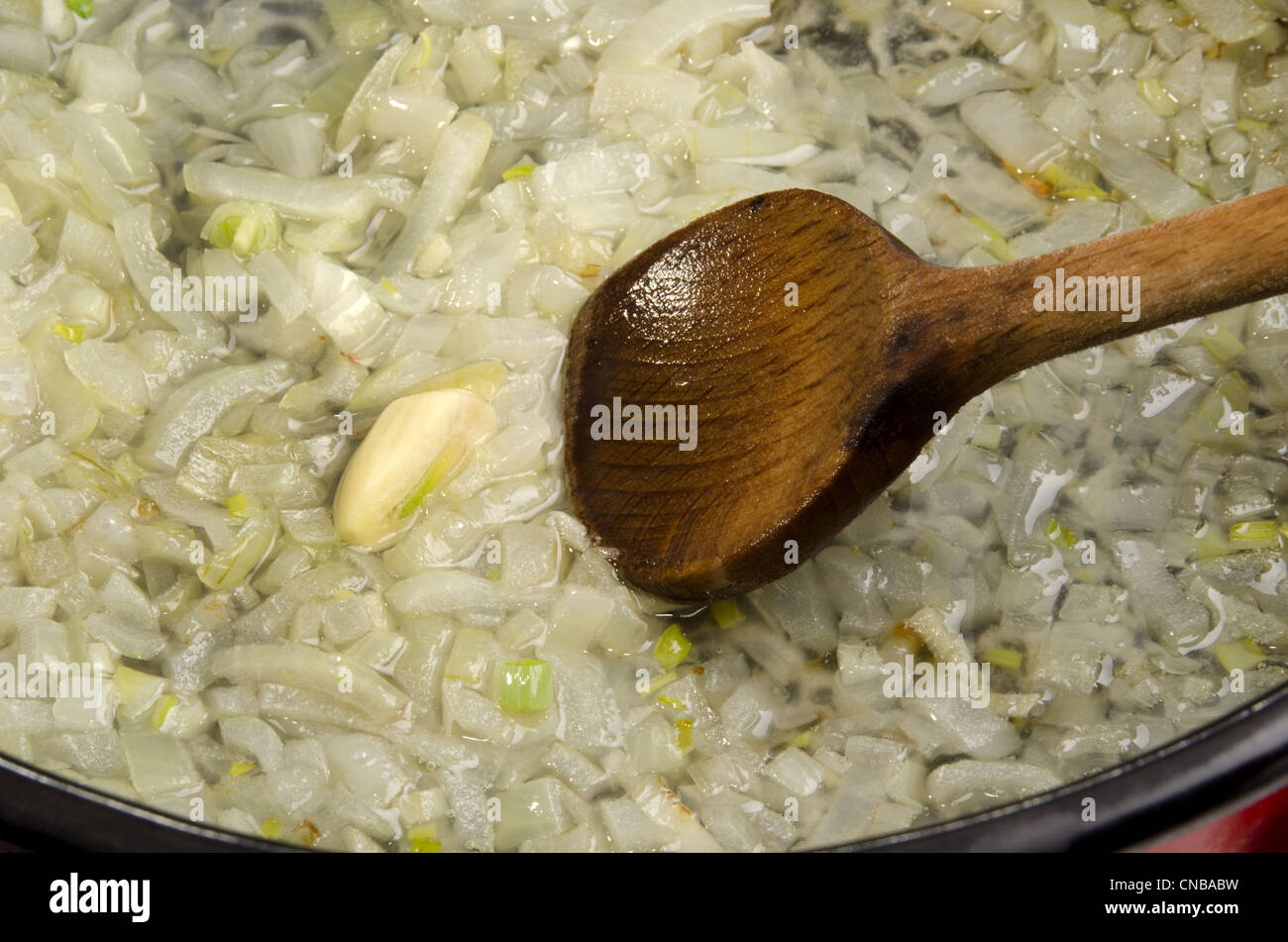 Garlic and onions are fried in a pot Stock Photo