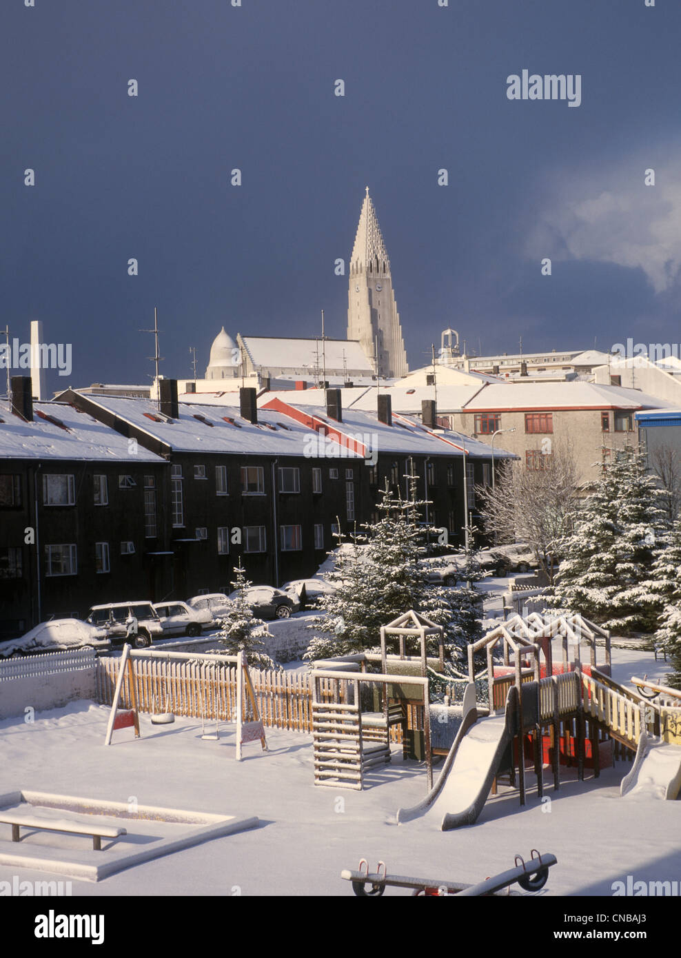 Iceland Reykjavik Hallgrimskirkja Church Apartment blocks and children's playground in foreground Stock Photo