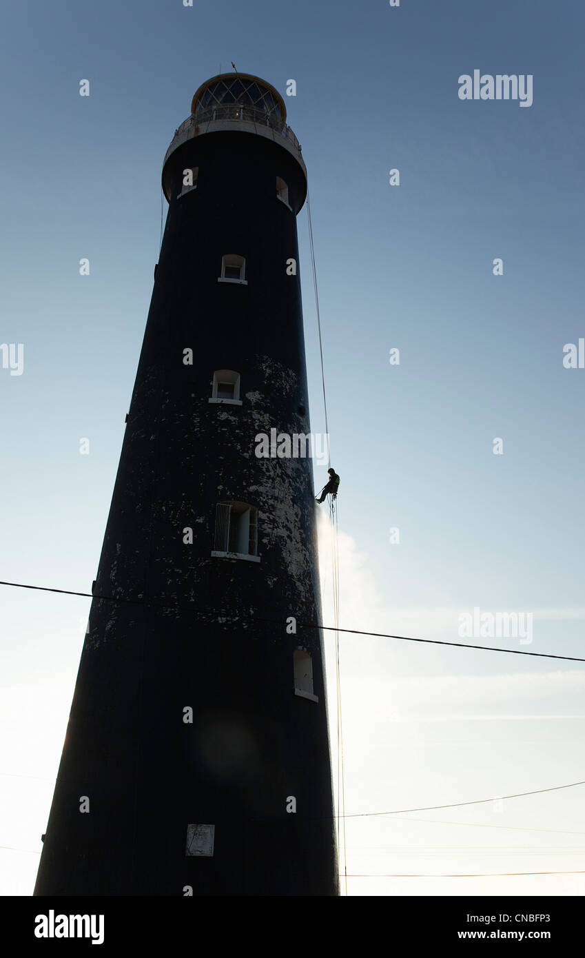 England, Kent, Romney Marsh, Dungeness, Man cleaning Lighthouse tower