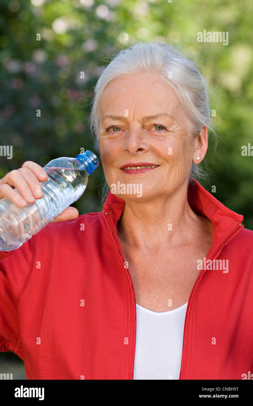 Elderly lady drinking water Stock Photo Alamy