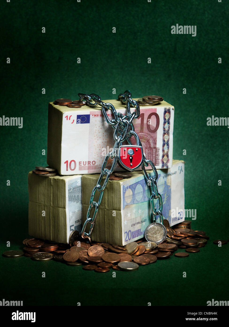 Bundles of Euro banknotes secured with chains and a lock Stock Photo