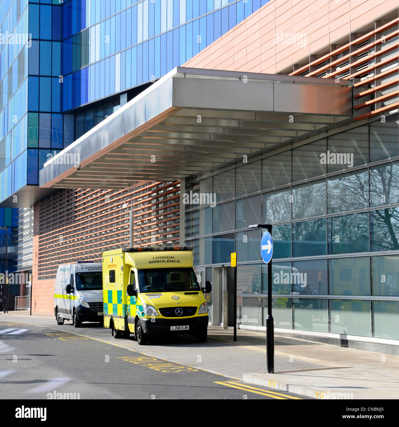 Ambulance outside exterior of A&E department in modern NHS healthcare hospital building Royal London Hospital Whitechapel Tower Hamlets East London UK Stock Photo