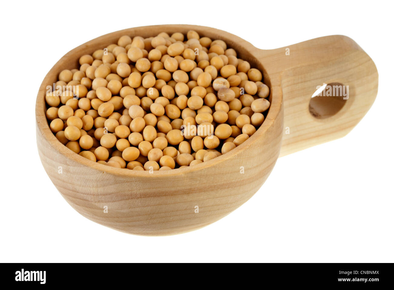 yellow soy beans on a rustic, wooden, scoop or bowl, isolated on white background Stock Photo