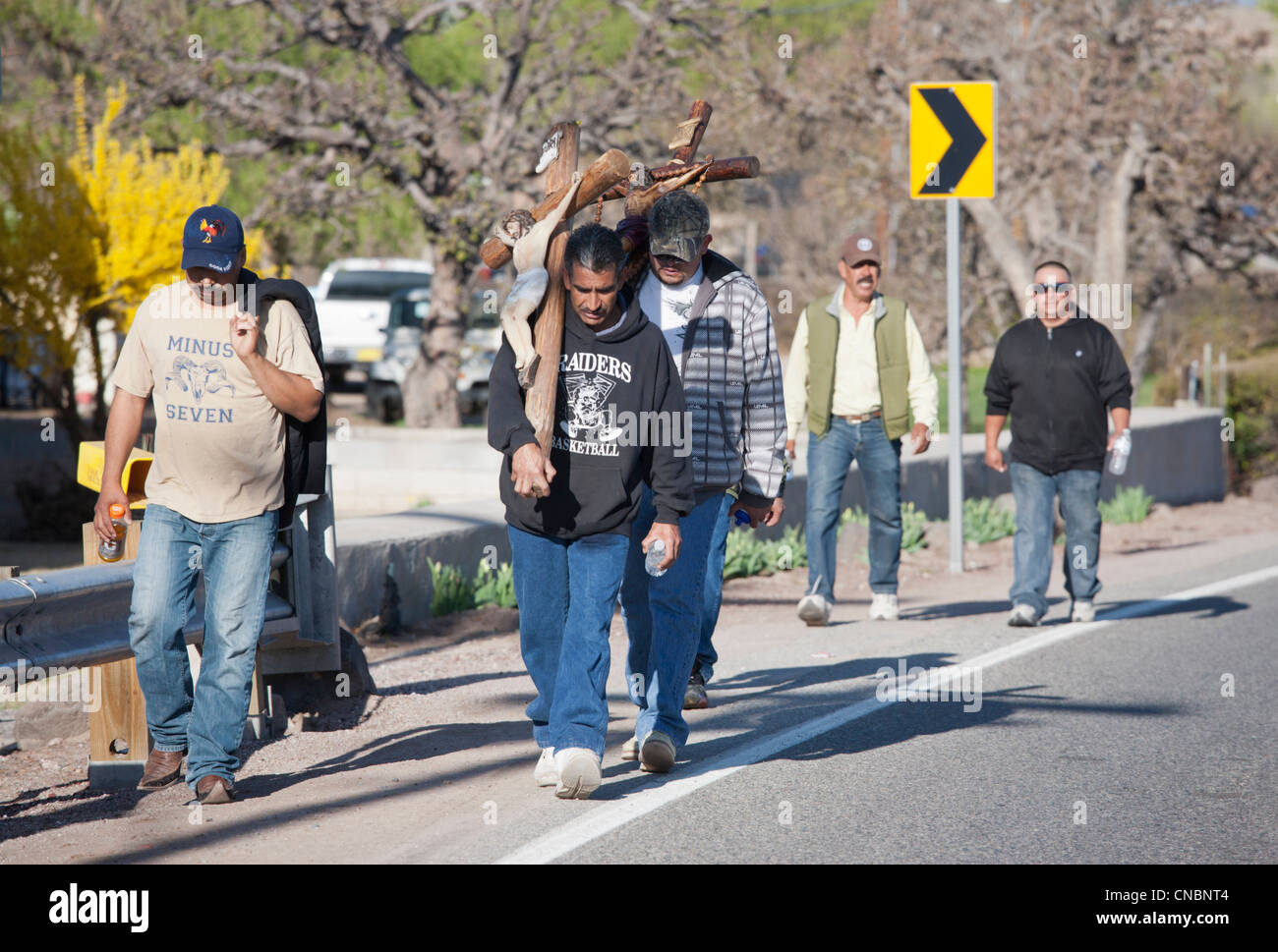 Pilgrim carrying a cross on his way to the Chimayo Sanctuary, New Mexico, during the Easter week. Stock Photo