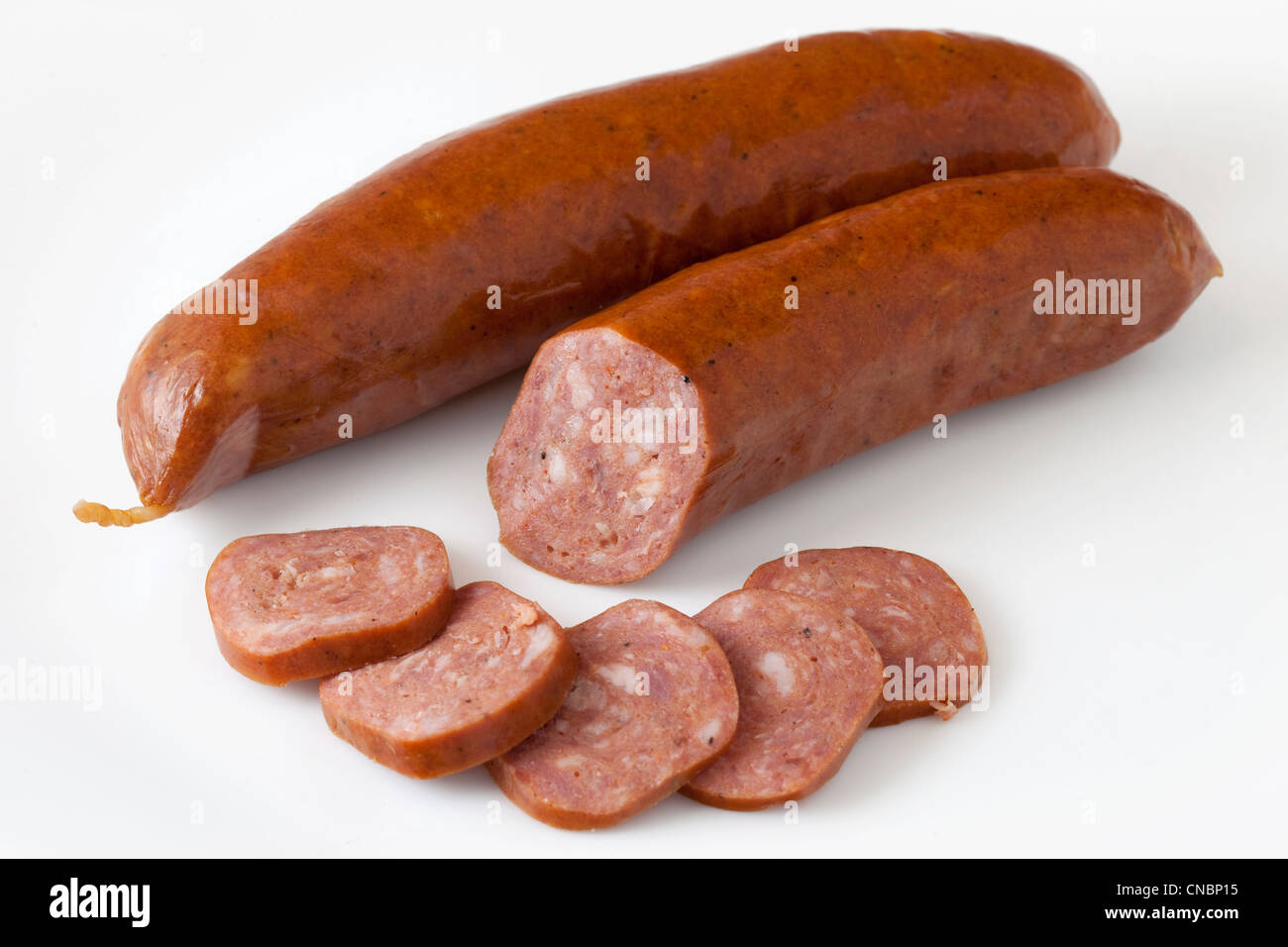lean buffalo (bison) bratwurst cut and sliced on white background Stock Photo