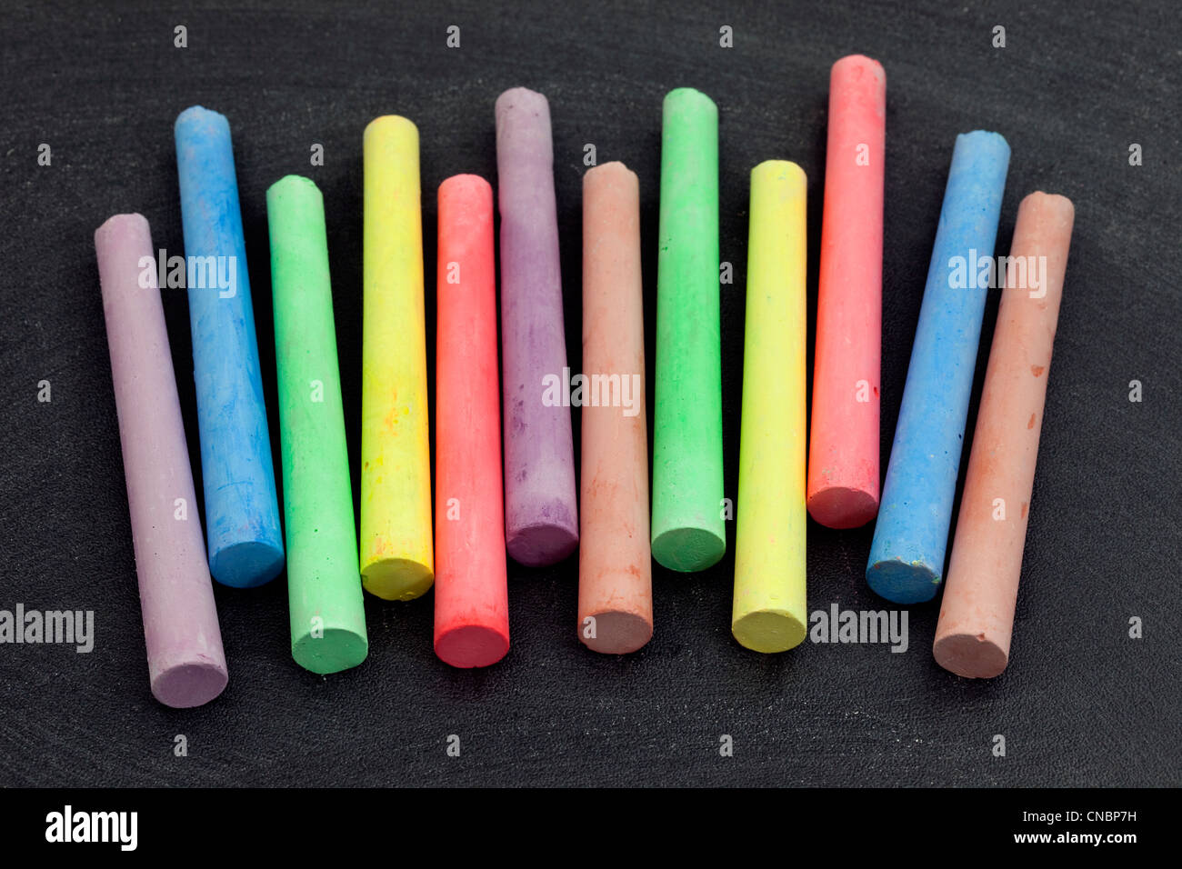 colorful chalk sticks on blackboard background Stock Photo Alamy