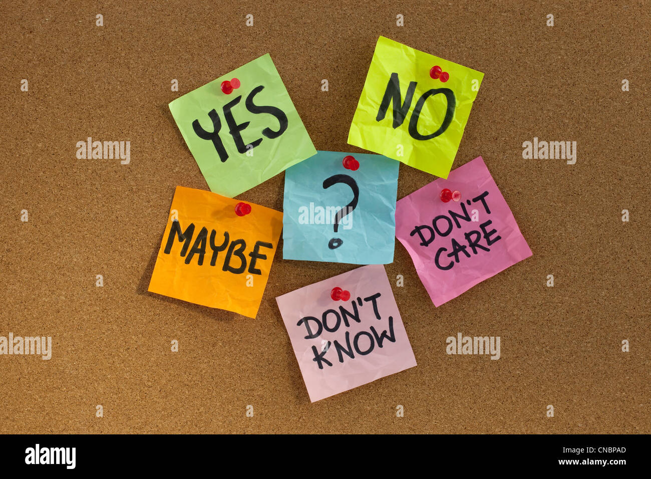 yes, no, maybe, ... undecided voter concept, colorful sticky notes on cork bulletin board Stock Photo
