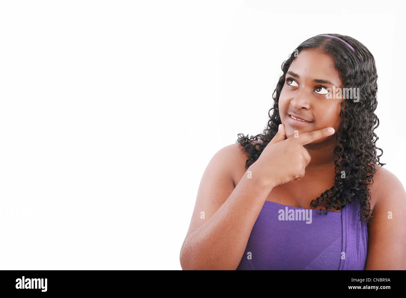 Portrait of teenage girl smiling and looking away Stock Photo