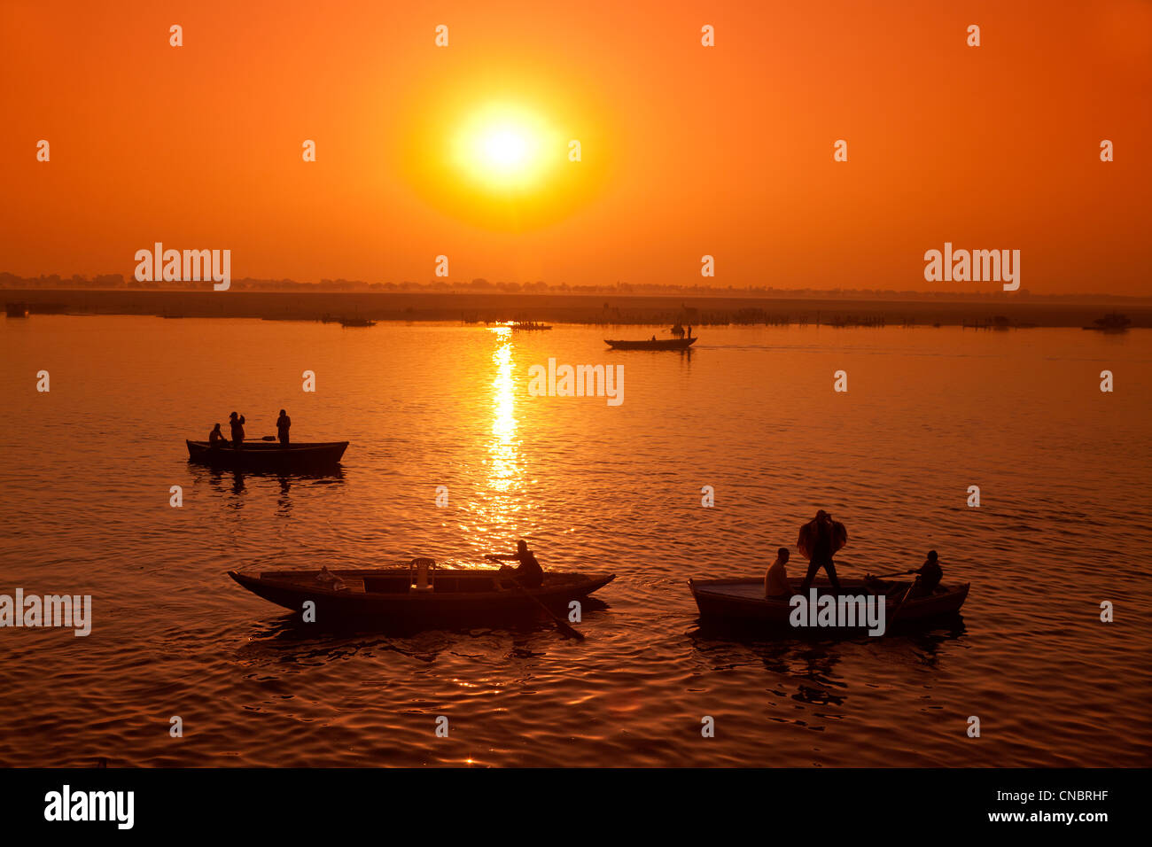 India, Uttar Pradesh, Varanasi, sunrise over the Ganges River Stock