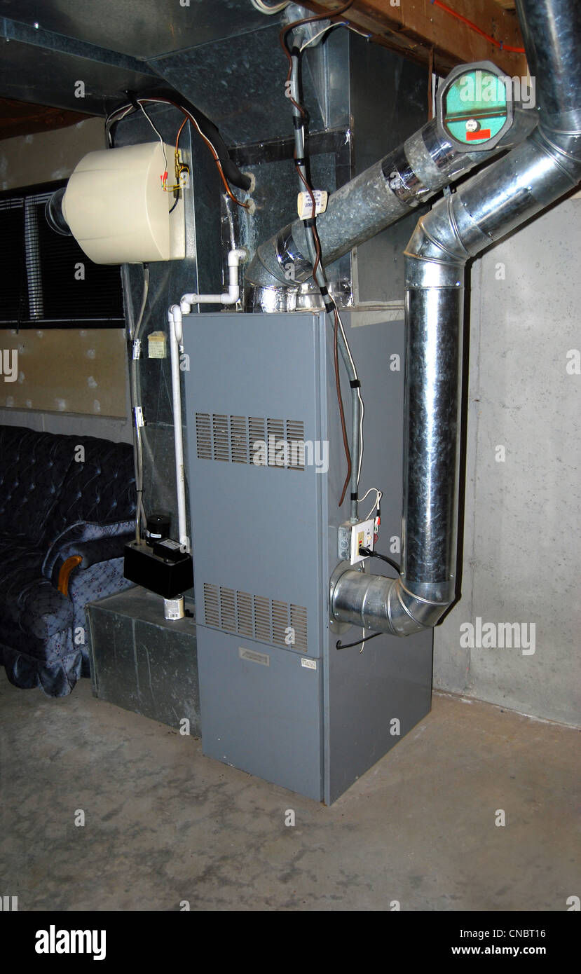 A residential oil furnace - forced hot air with central air conditioning and an in-line humidifier as well. Stock Photo