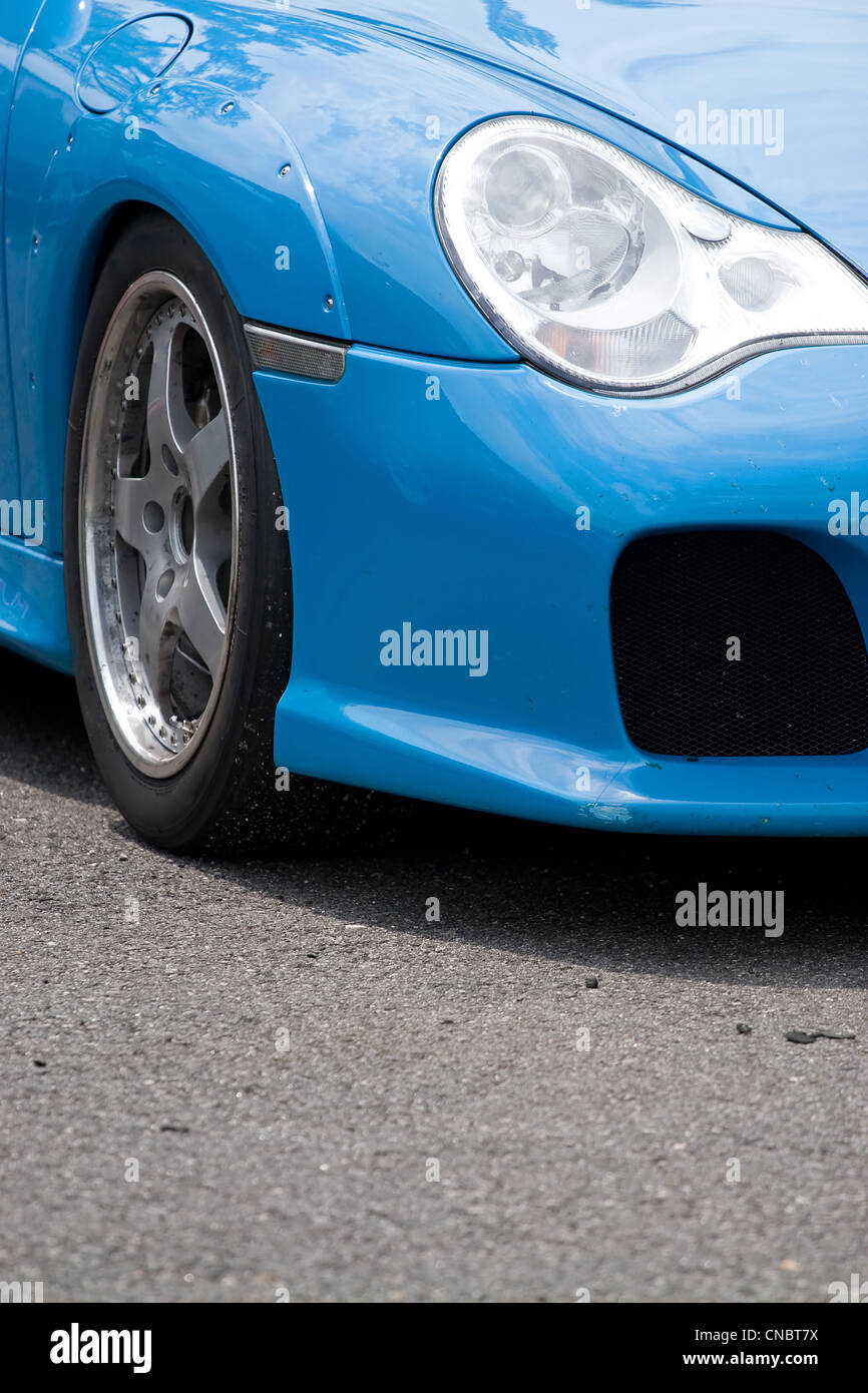 A closeup of the custom rims and widebody kit on a modern sports car with plenty of copyspace. Stock Photo