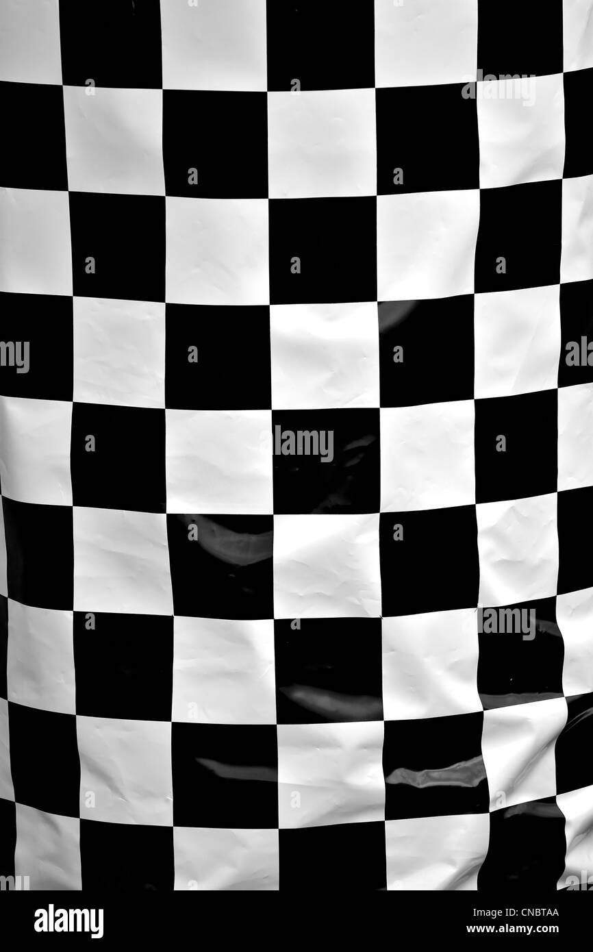 A black and white checkered flag texture up close. Stock Photo