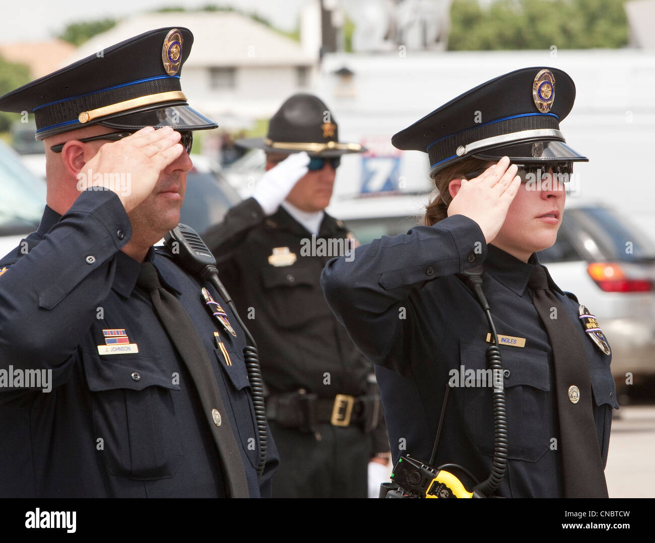 officers salute during funeral for Austin Police Officer Jaime Padron, who was killed in the line of duty in a full ceremony Stock Photo