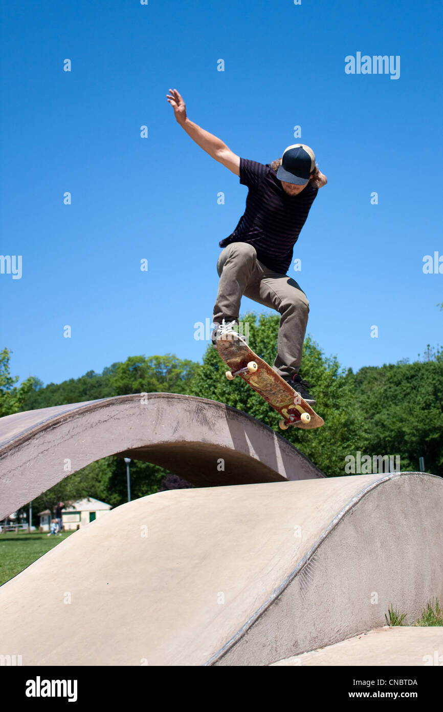 Action shot of a skateboarder performing a jump at a skate park Stock Photo  - Alamy