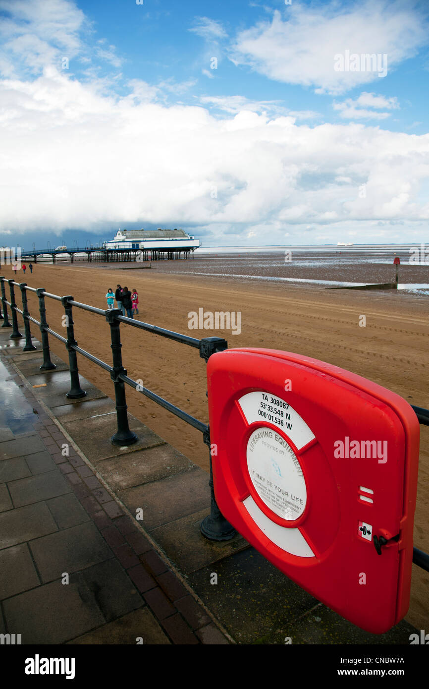 Cleethorpes, Lincolnshire, Pier a traditional victorian pier which is now a nightclub & restaurant people on beach & life ring Stock Photo