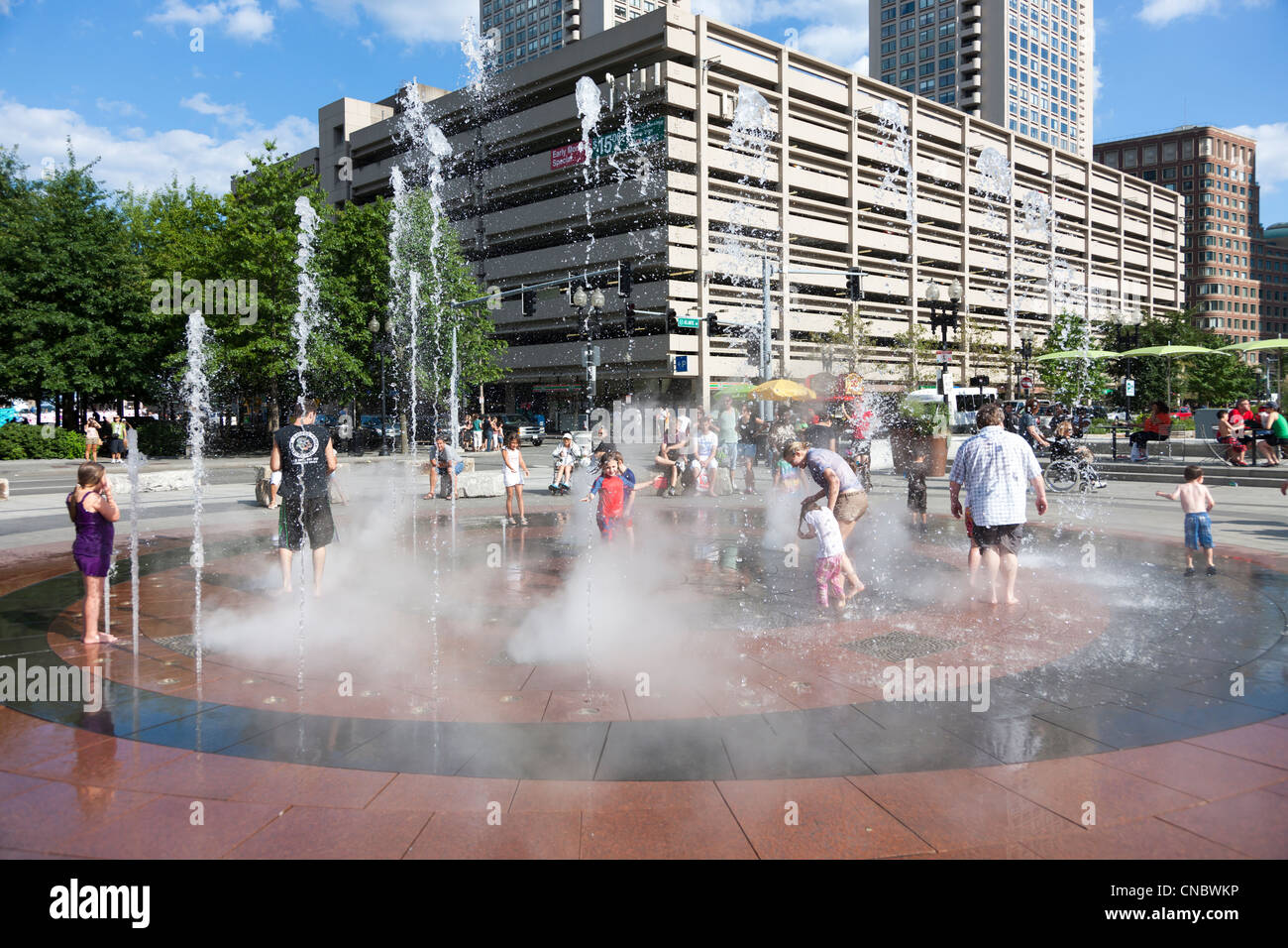 Families and kids enjoy the fountain in the Rose Kennedy Greenway in Boston, Massachusetts. Stock Photo