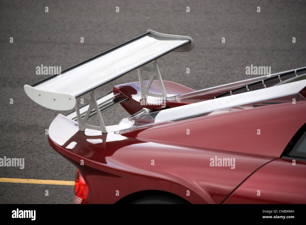 Closeup detail of a custom racing spoiler on the rear of a sports car. Stock Photo