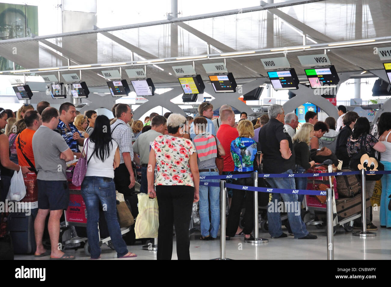 Crowded check-in at departure terminal, Suvarnabhumi International Airport, Bangkok, Samut Prakan Province, Thailand Stock Photo