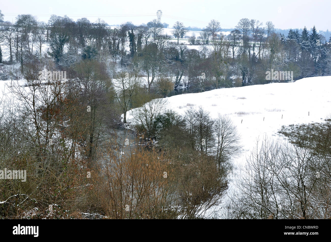 River 'La Varenne' under snow, from side: Orne department in Normandy, on the other : Mayenne department in Pays de la Loire. France, Europe. Stock Photo
