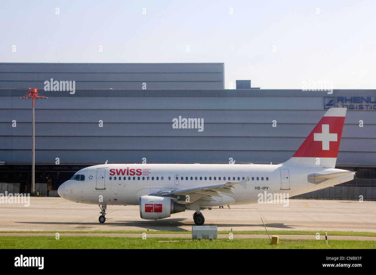 Horizontal view of a Swiss International Air lines plane waiting on the tarmac to take-off on a sunny day. Stock Photo