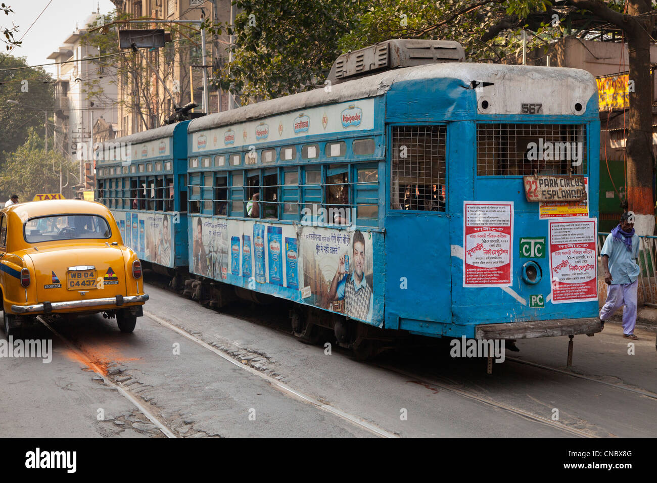 India, West Bengal, Kolkata (calcutta), tram and yellow ambassador taxi Stock Photo