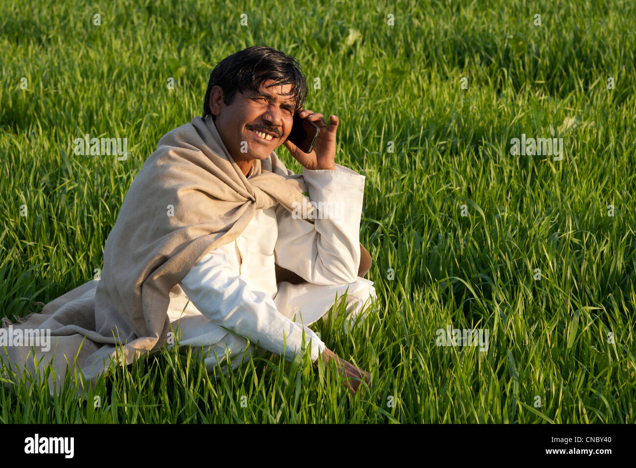 India, Uttar Pradesh, farmer using smartphone Stock Photo