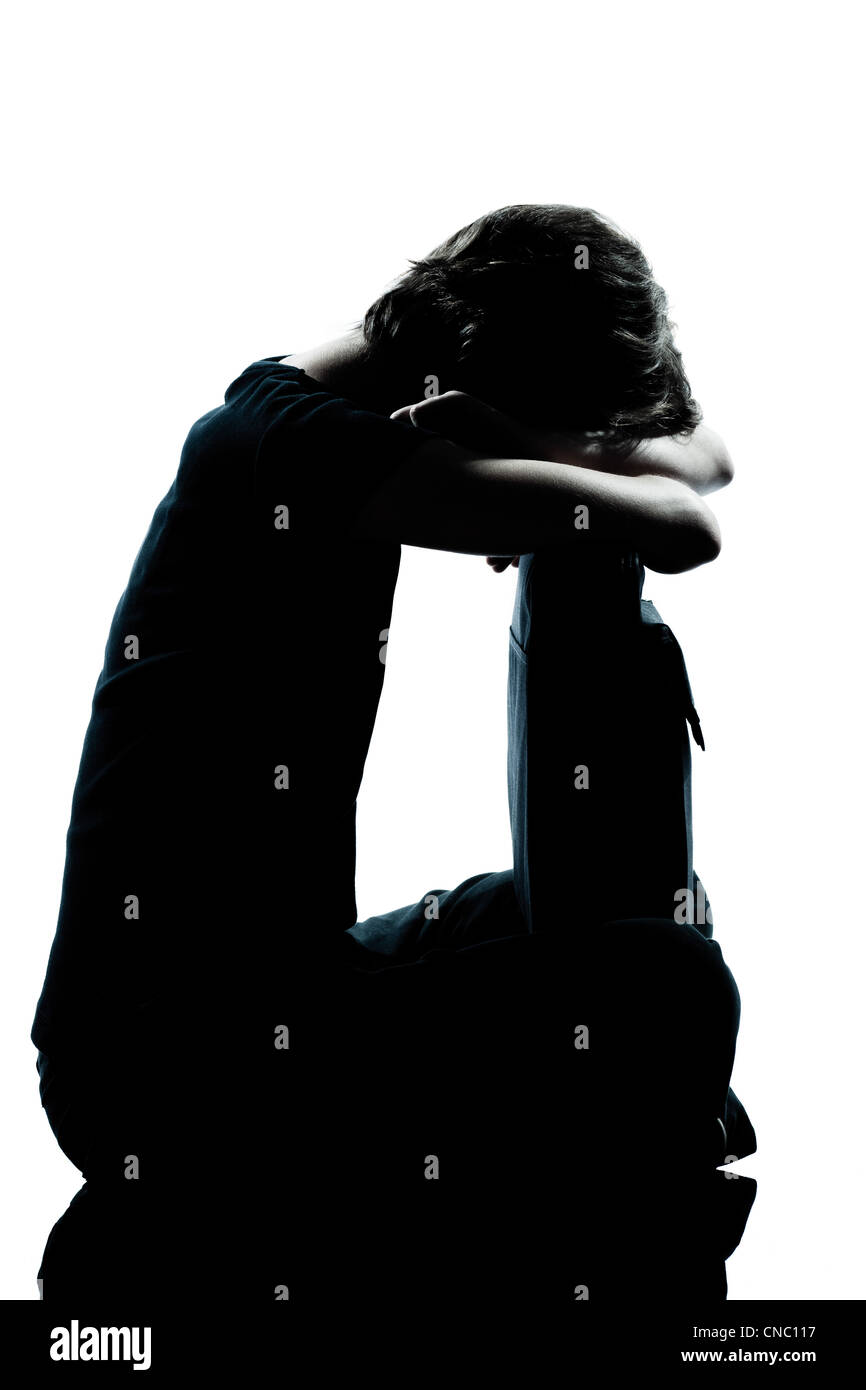one caucasian young teenager silhouette girl crying sad full length in studio cut out isolated on white background Stock Photo