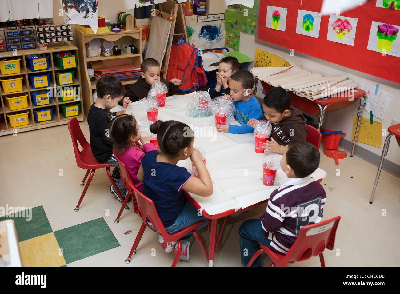 preschool children in the classroom blowing bubbles Stock Photo Alamy