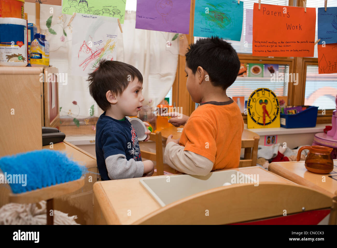 Two preschool boys talking in the classroom Stock Photo - Alamy