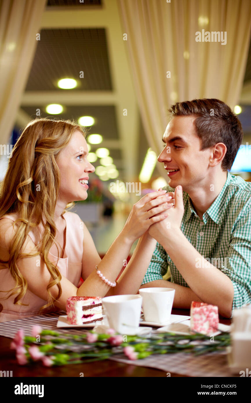 A young happy woman and her boyfriend having nice time in restaurant Stock Photo