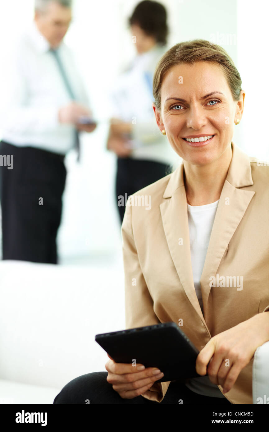 Smiling business woman looking at camera in working environment Stock ...