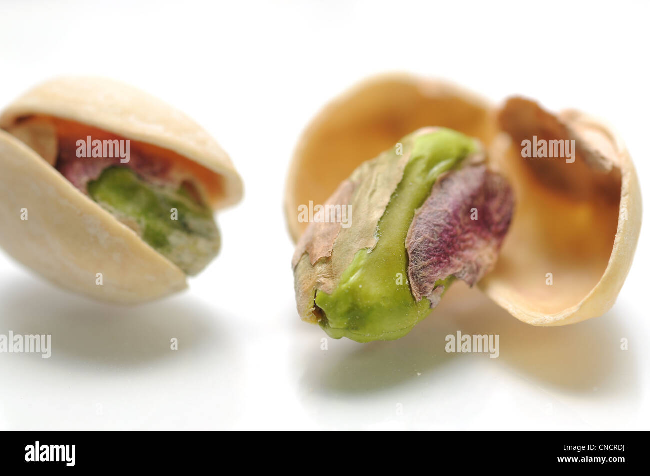 Macro salted pistachios on white background Stock Photo Alamy