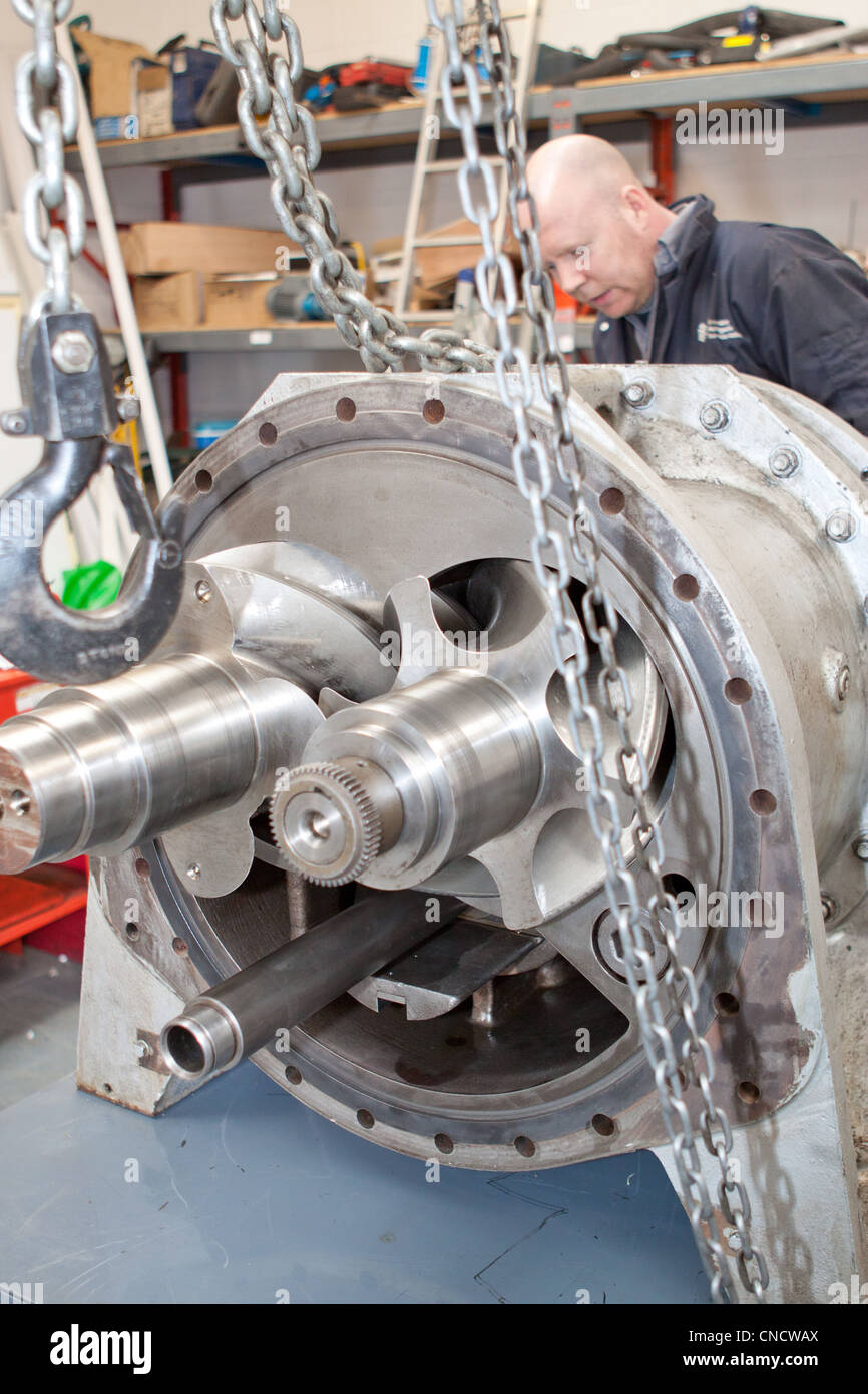 Engineer checking the casing on a industrial refrigeration machine