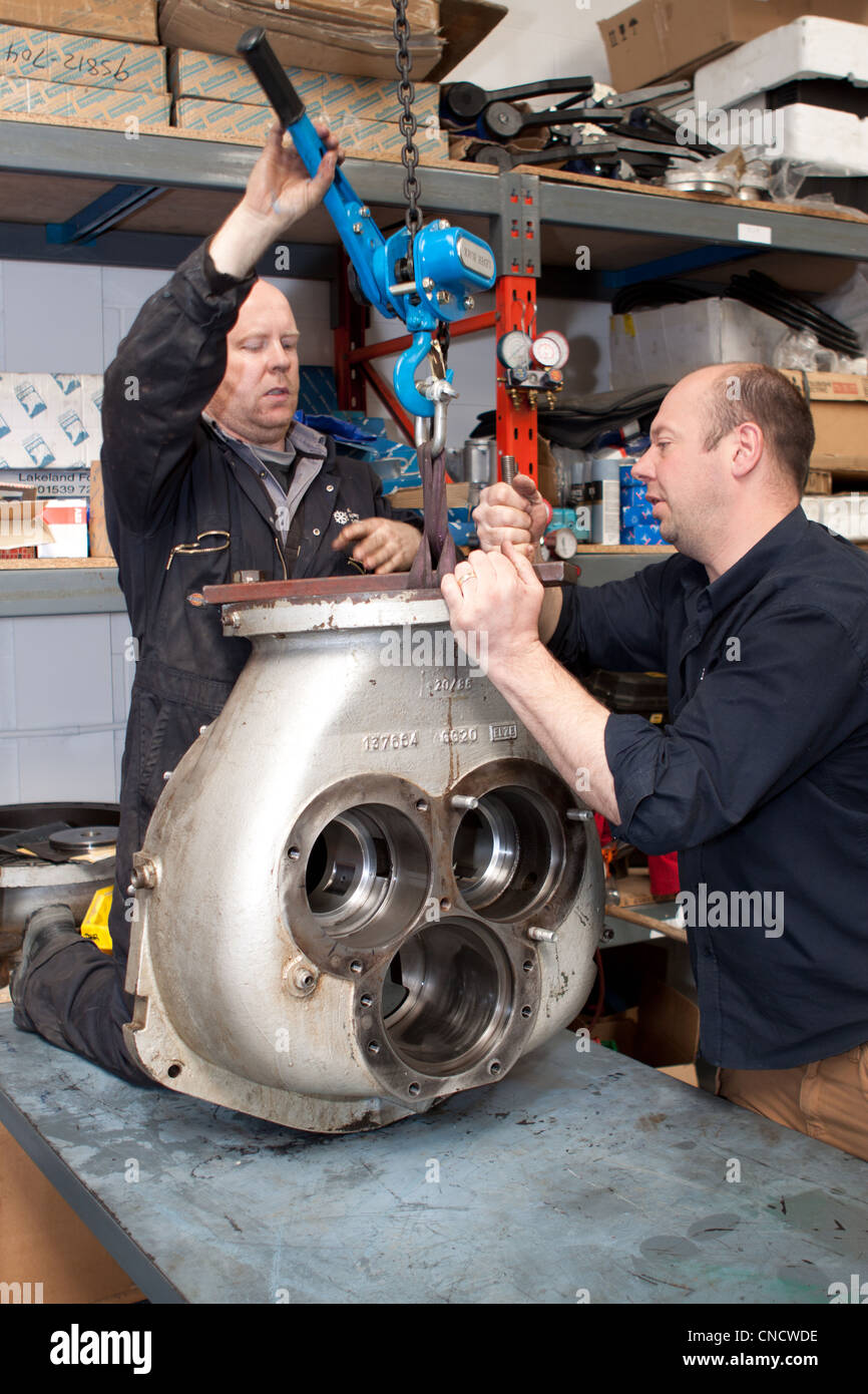 Engineers working on a refrigeration machine Stock Photo Alamy