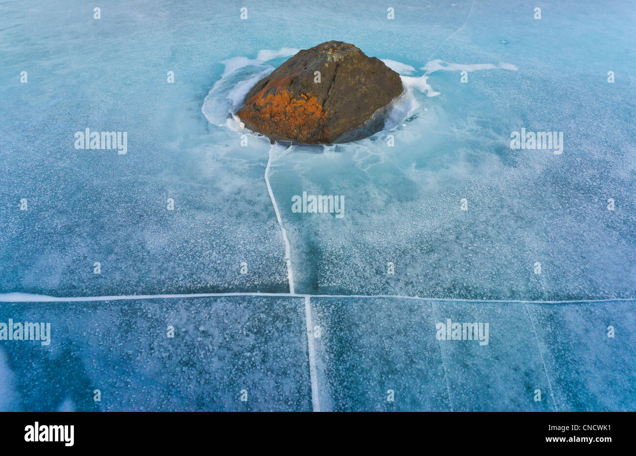 Rock in Frozen Hidden Lake, Chugach State Park, Southcentral Alaska, Winter Stock Photo