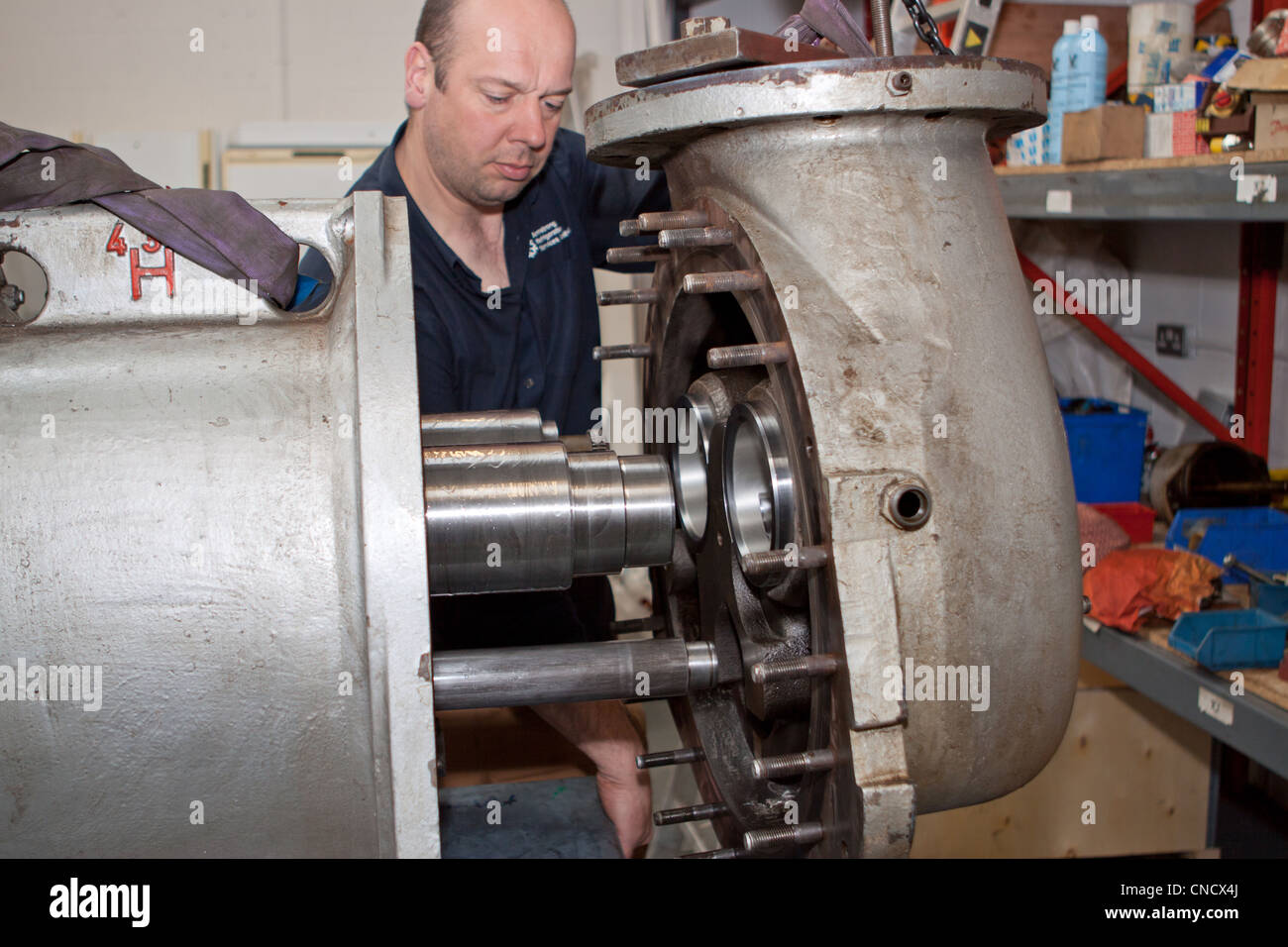 Engineers working on a heavy duty pump Stock Photo Alamy