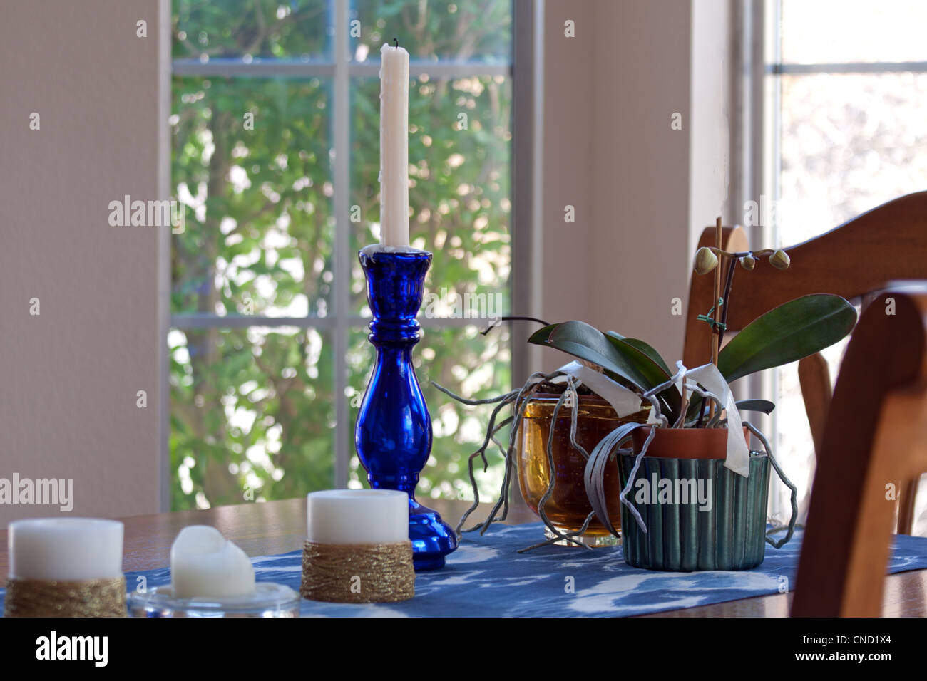 blue candle holder on dining table with chairs Stock Photo Alamy
