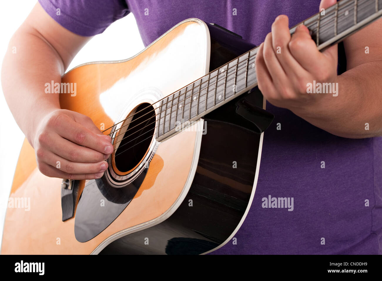 Closeup of a mans hands strumming and electric acoustic guitar isolated over a white background. Stock Photo