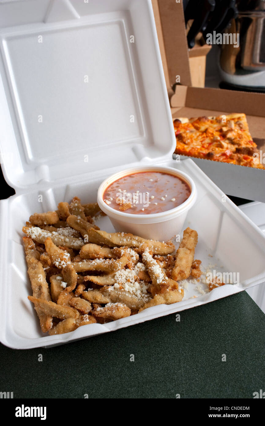Italian fast food in takeout containers. Pizza and fried battered eggplant strips. Stock Photo