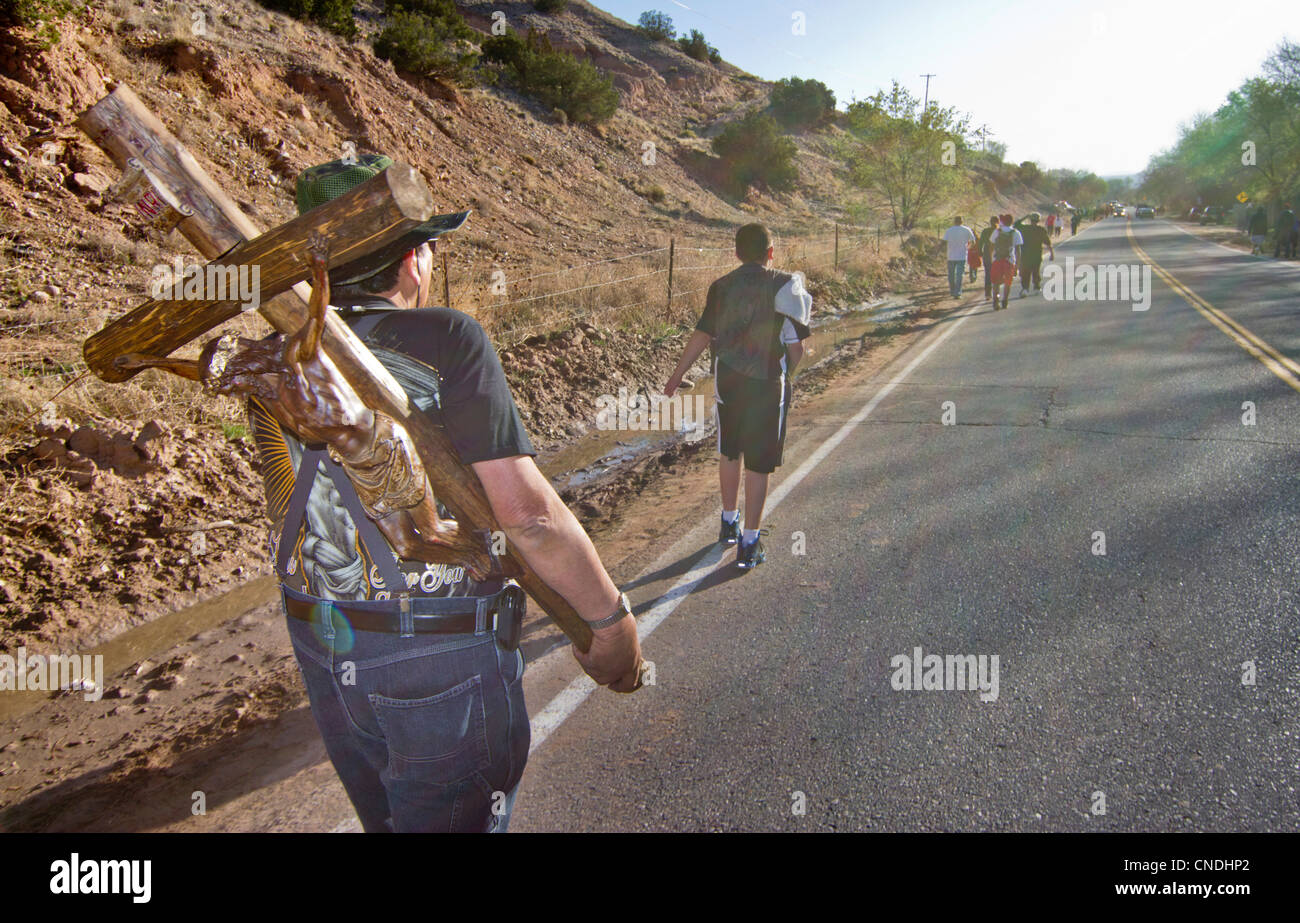 Pilgrim carrying a cross on his way to the Chimayo Sanctuary, New Mexico, during the Easter week. Stock Photo
